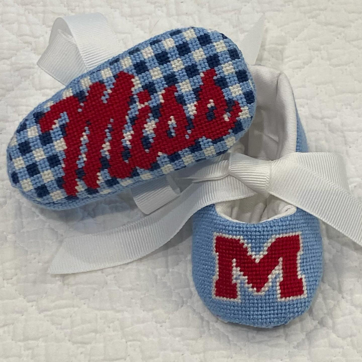 Finished needlepoint baby shoe in blue gingham from @pinpointneedlepoint on Instagram